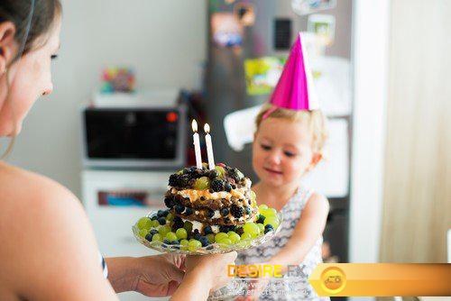 Mother with her cute daughter and birthday cake with candle 9X JPEG