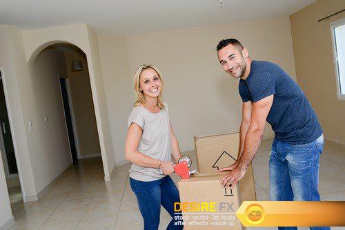 Happy young couple, cardboard boxes moving into their new house 11X JPEG