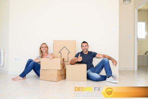 Happy young couple, cardboard boxes moving into their new house 11X JPEG
