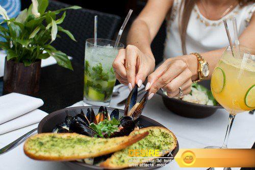 Man holding his girlfriend\'s hand with engagement ring at the restaurant 9X JPEG