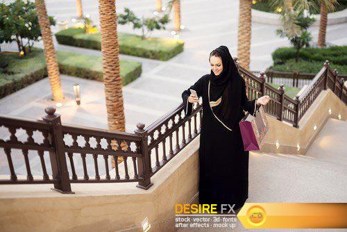 Arabian woman typing on smart phone and smiling - 6 UHQ JPEG