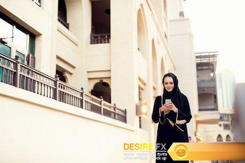 Arabian woman typing on smart phone and smiling - 6 UHQ JPEG