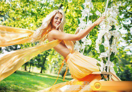 Attractive blonde beauty on a flower swing in a park - 8 UHQ JPEG